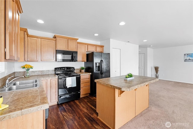 kitchen featuring a sink, a center island, black appliances, and recessed lighting
