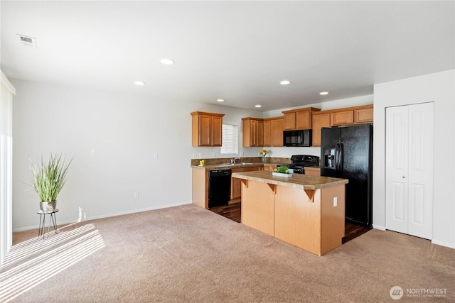 kitchen with a center island, a breakfast bar area, black appliances, and dark carpet