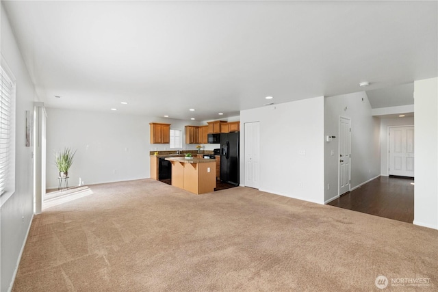 unfurnished living room with recessed lighting, baseboards, and dark carpet