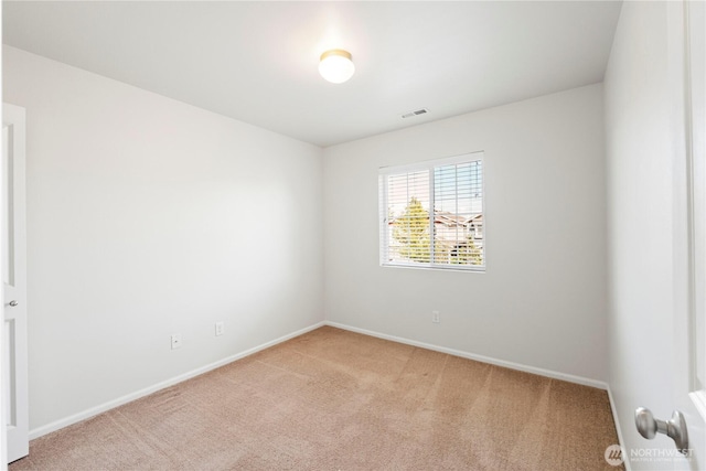 empty room featuring baseboards, carpet flooring, and visible vents