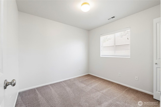 carpeted empty room with visible vents and baseboards