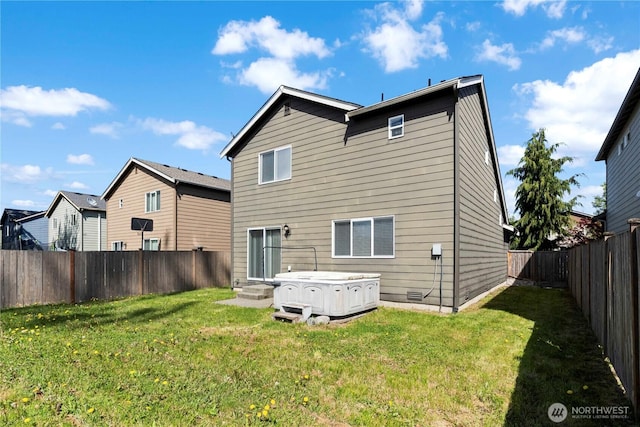 rear view of house with a fenced backyard and a yard