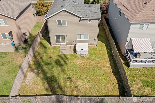 rear view of property with a patio and a fenced backyard