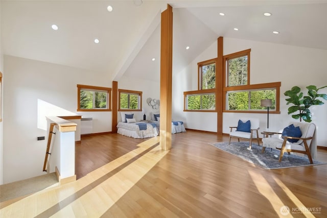 additional living space with baseboards, wood finished floors, high vaulted ceiling, and recessed lighting
