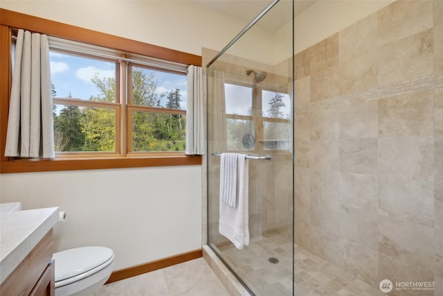 full bathroom with a tile shower, toilet, vanity, and tile patterned floors