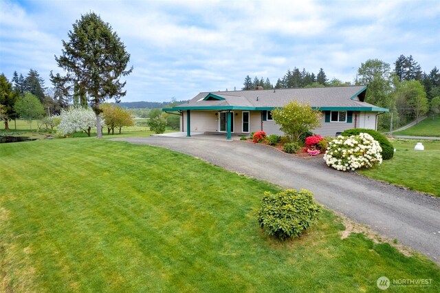 single story home featuring aphalt driveway, a chimney, and a front lawn
