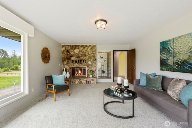 living room featuring a healthy amount of sunlight, carpet, and a fireplace
