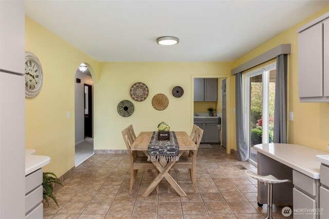 dining area with arched walkways