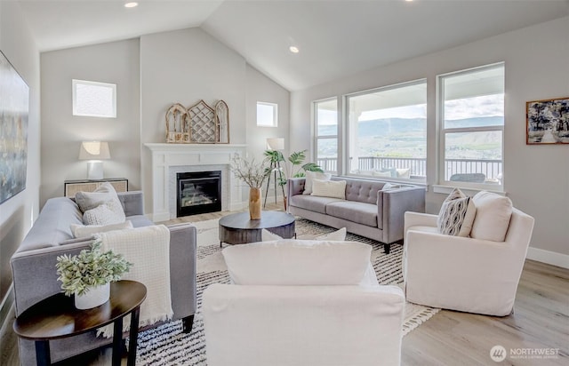 1580 S Kelvin Ct, East Wenatchee, WA 98802 - living area with light wood-style floors, vaulted ceiling, recessed lighting, a fireplace, and baseboards