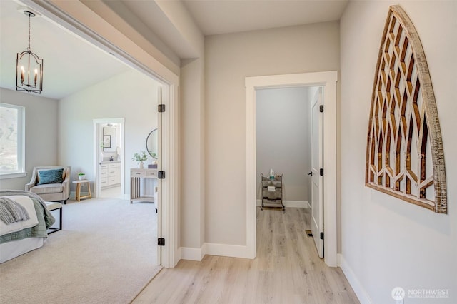 1580 S Kelvin Ct, East Wenatchee, WA 98802 - hall featuring a chandelier, light wood-style floors, and baseboards