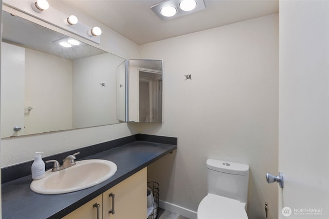2534 S 317th St Unit 103, Federal Way, WA 98003 - bathroom featuring vanity, toilet, and baseboards