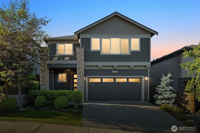 1221 199th St SE, Bothell, WA 98012 - view of front facade featuring a balcony, a garage, driveway, and board and batten siding