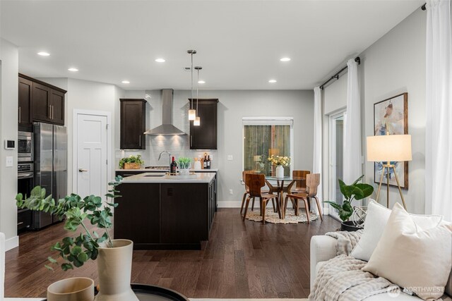 1221 199th St SE, Bothell, WA 98012 - kitchen with wall chimney exhaust hood, stainless steel appliances, light countertops, dark wood-type flooring, and dark brown cabinetry