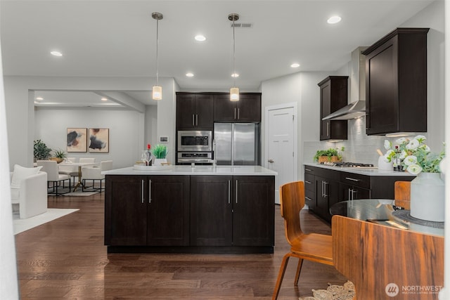 1221 199th St SE, Bothell, WA 98012 - kitchen with appliances with stainless steel finishes, wall chimney range hood, dark wood-style flooring, light countertops, and recessed lighting