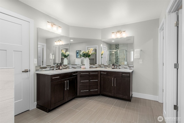 1221 199th St SE, Bothell, WA 98012 - bathroom featuring a shower stall, double vanity, and baseboards