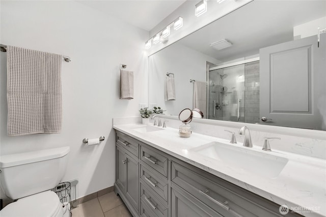 215 100th St SW Unit B307, Everett, WA 98204 - bathroom with toilet, tile patterned flooring, a shower stall, double vanity, and baseboards