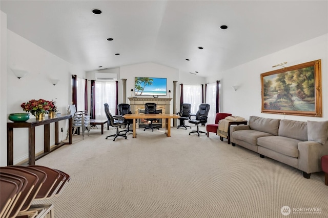 215 100th St SW Unit B307, Everett, WA 98204 - living room with vaulted ceiling, carpet floors, a wall mounted air conditioner, healthy amount of natural light, and a fireplace