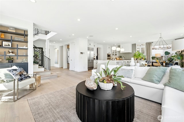 living area with stairway, light wood-type flooring, and recessed lighting