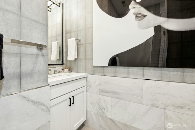 bathroom featuring tile walls and vanity