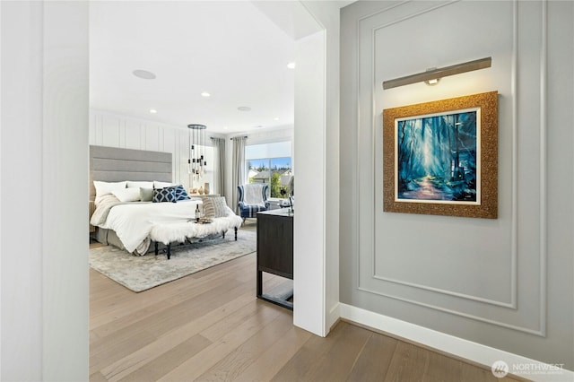 bedroom with baseboards and wood finished floors