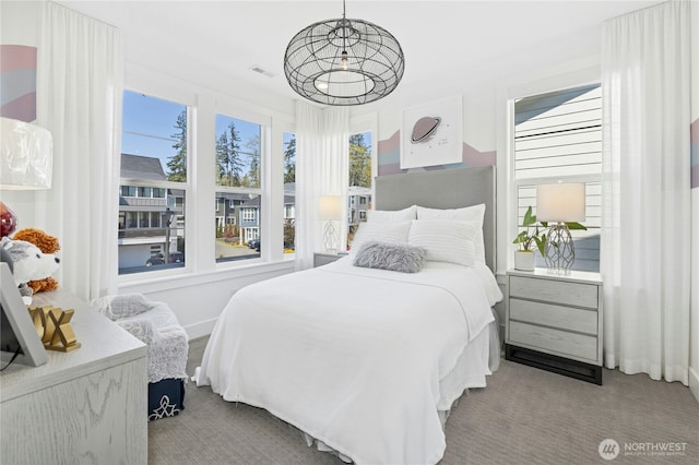 carpeted bedroom featuring visible vents