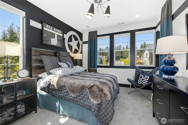 bedroom featuring carpet floors, a chandelier, and multiple windows