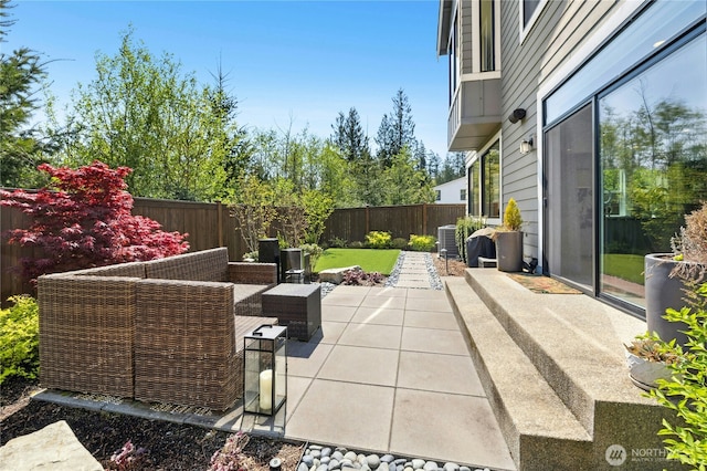 view of patio with an outdoor living space, a fenced backyard, and central air condition unit