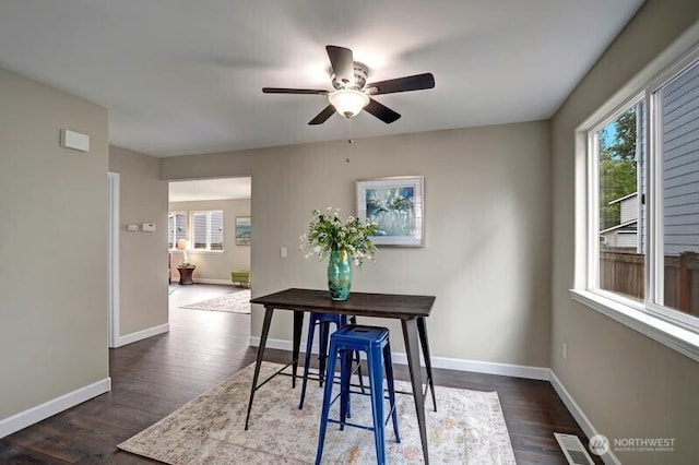 dining area with a ceiling fan, visible vents, dark wood-style floors, and a healthy amount of sunlight