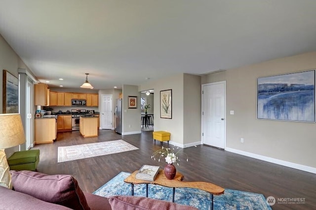 living room with baseboards, recessed lighting, and dark wood-style floors