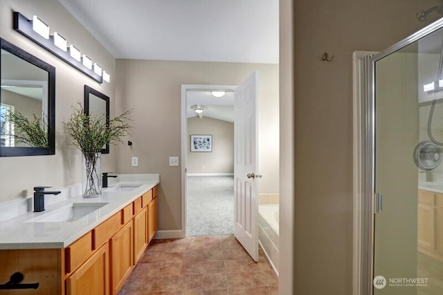 bathroom featuring a garden tub, a sink, double vanity, and a shower stall