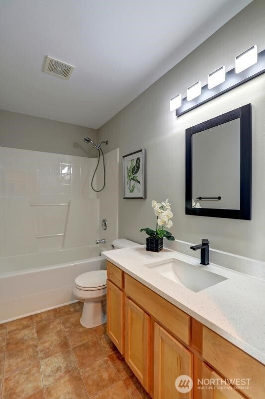 full bathroom with shower / bath combination, vanity, toilet, and visible vents