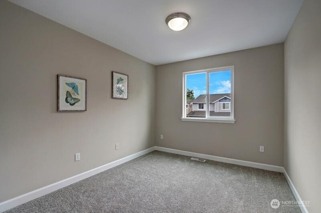 unfurnished room featuring carpet floors, baseboards, and visible vents