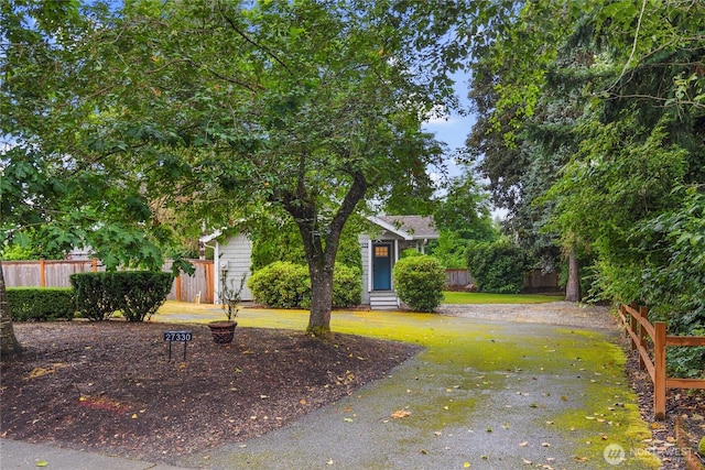 view of front of house with fence, a front yard, and entry steps