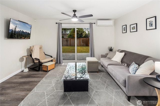 living area featuring baseboards, ceiling fan, a wall unit AC, and wood finished floors