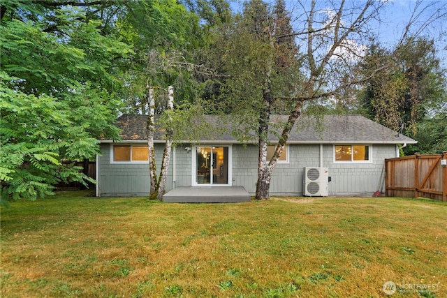 back of house with a yard, fence, ac unit, and a shingled roof