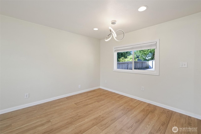 unfurnished room with baseboards, light wood-type flooring, a chandelier, and recessed lighting