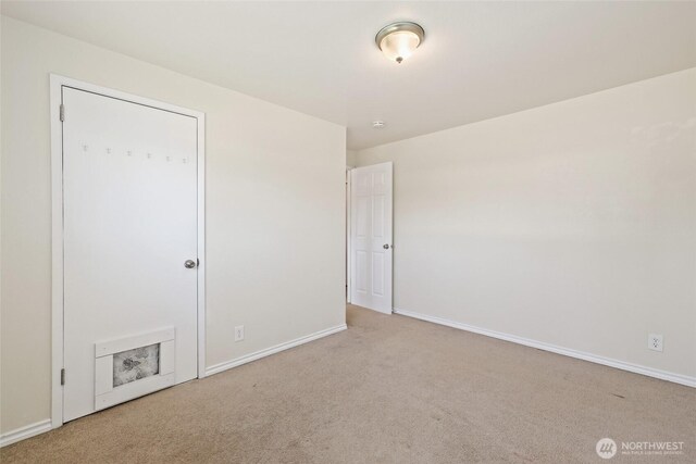 unfurnished bedroom featuring carpet floors and baseboards