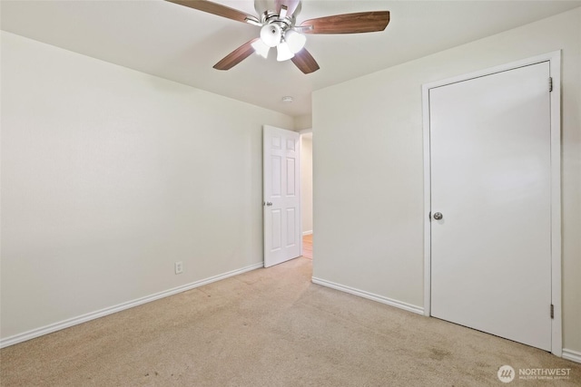 unfurnished bedroom with carpet, baseboards, and a ceiling fan