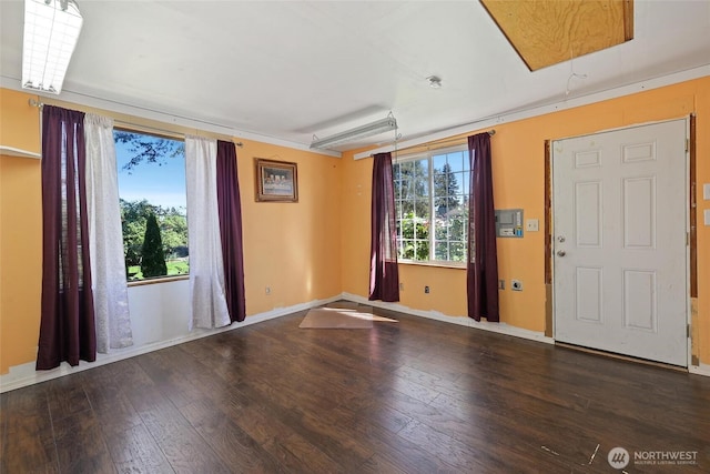 spare room with hardwood / wood-style floors and baseboards