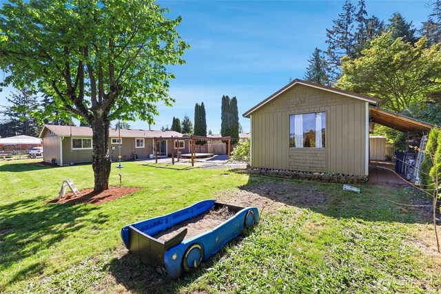 view of yard featuring a patio and an outdoor structure