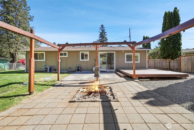 back of house with a deck, an outdoor fire pit, central AC, and stucco siding