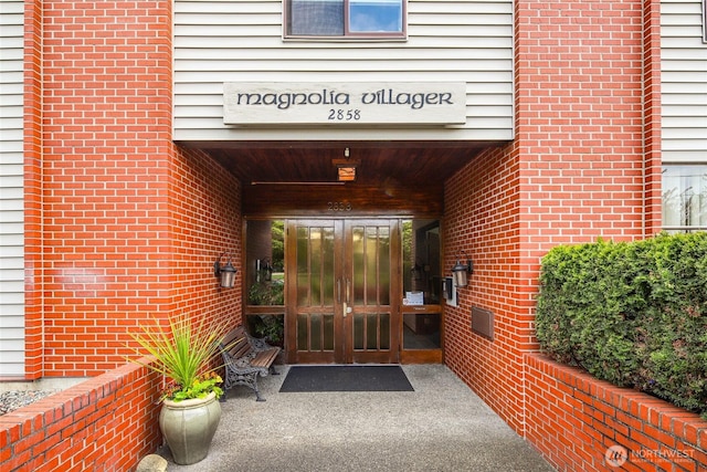 2858 32nd Ave W Unit 102, Seattle, WA 98199 - view of exterior entry featuring french doors and brick siding