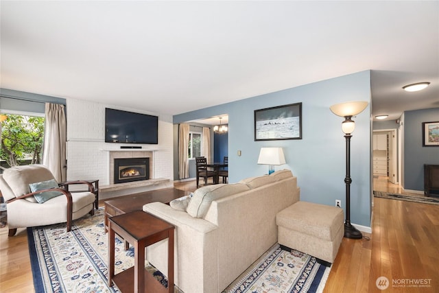2858 32nd Ave W Unit 102, Seattle, WA 98199 - living room with light wood-type flooring, baseboards, and a fireplace