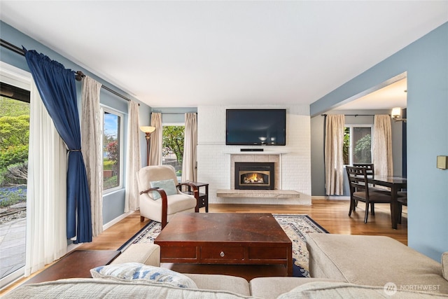 2858 32nd Ave W Unit 102, Seattle, WA 98199 - living area featuring a brick fireplace and wood finished floors
