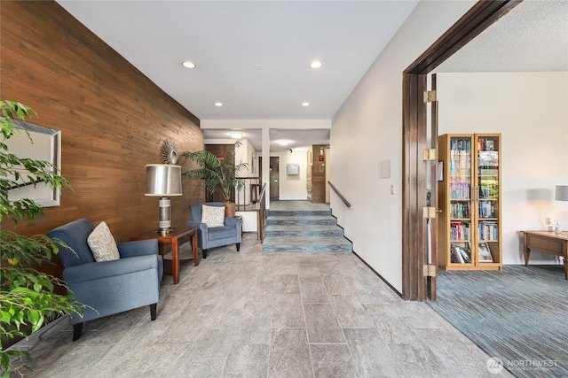 2858 32nd Ave W Unit 102, Seattle, WA 98199 - corridor with wooden walls, recessed lighting, and stairway