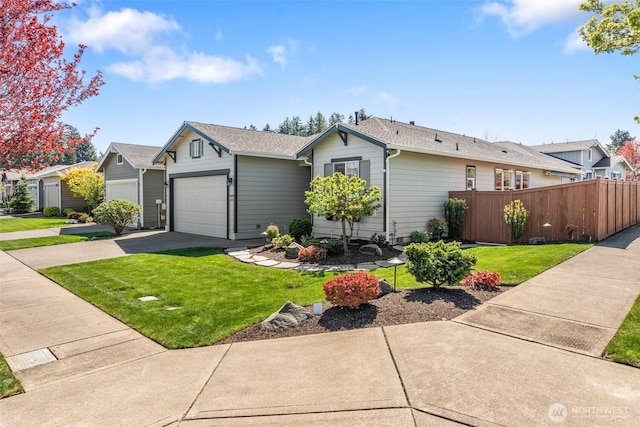 view of front of property featuring fence, concrete driveway, an attached garage, and a front lawn