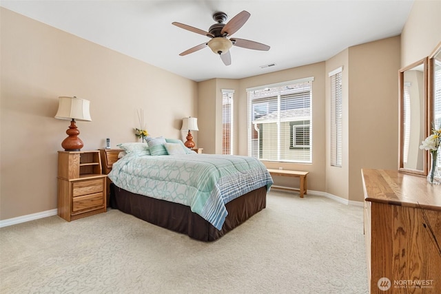 bedroom featuring baseboards, visible vents, a ceiling fan, and light carpet