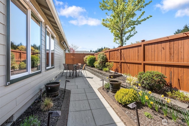 view of patio featuring outdoor dining space and a fenced backyard