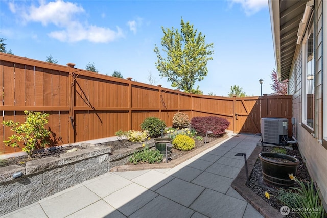 view of patio / terrace featuring a gate, cooling unit, and a fenced backyard