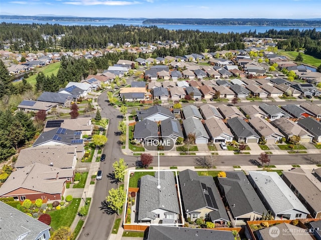 drone / aerial view with a water view and a residential view